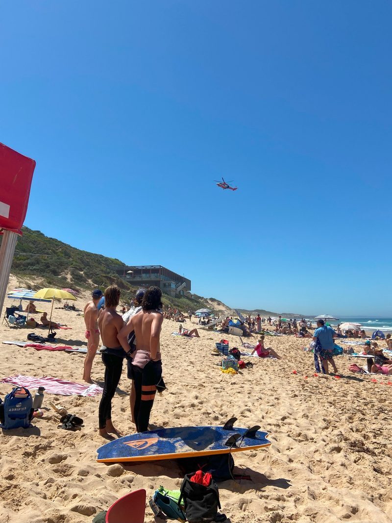 Air ambulance helicopter arriving over the beach at Portsea