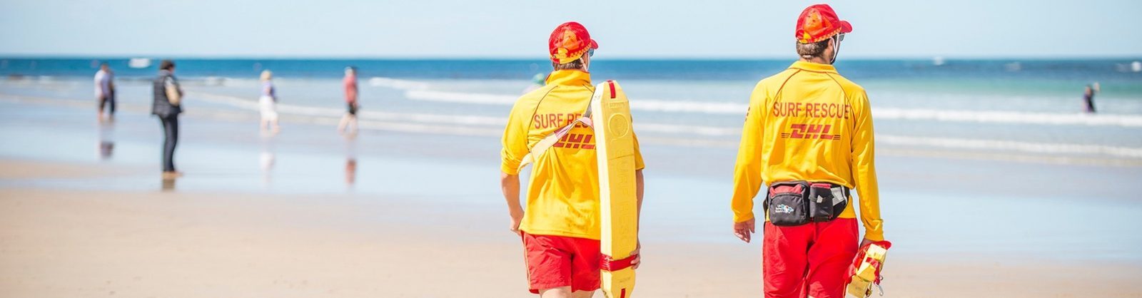 Two Life Saving Victoria lifesavers in red and yellow patrolling the shoreline