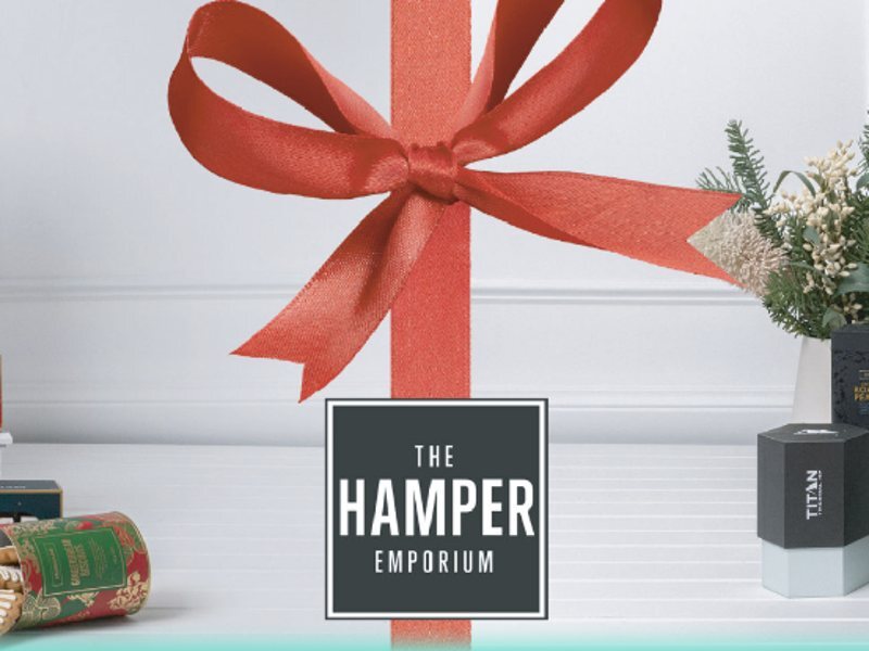 Christmas hamper with branded gifts and a red ribbon